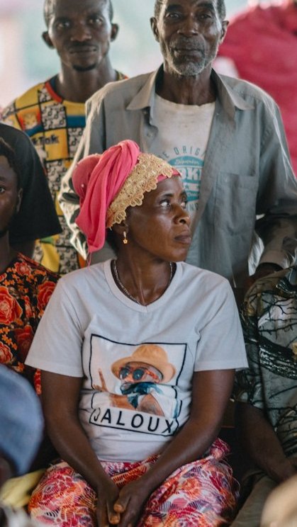 Woman at a community meeting looking away from the camera